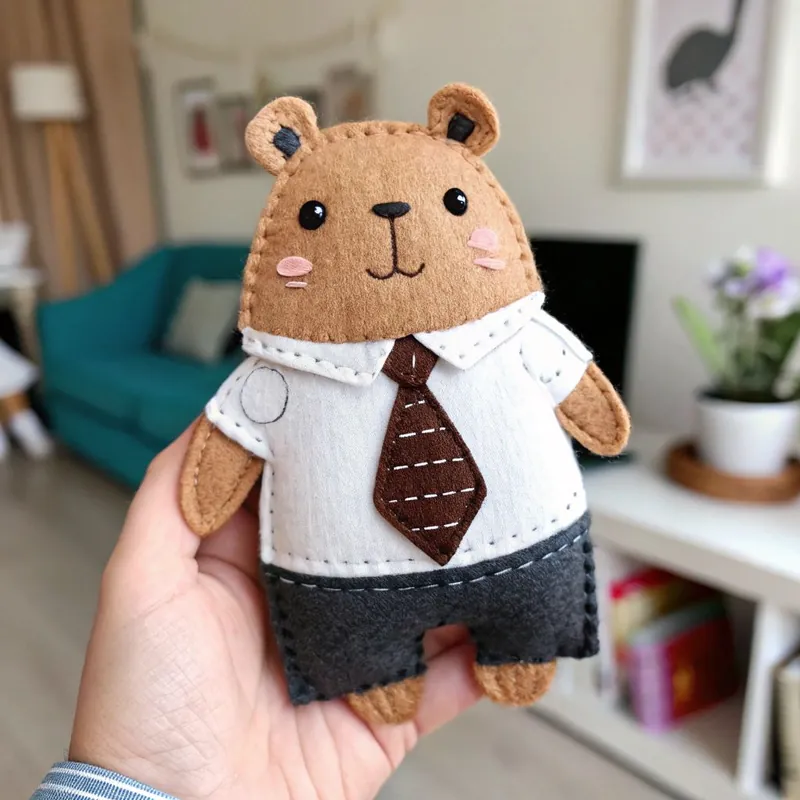 Finished felt capybara in a white shirt, striped brown tie and dark shorts
