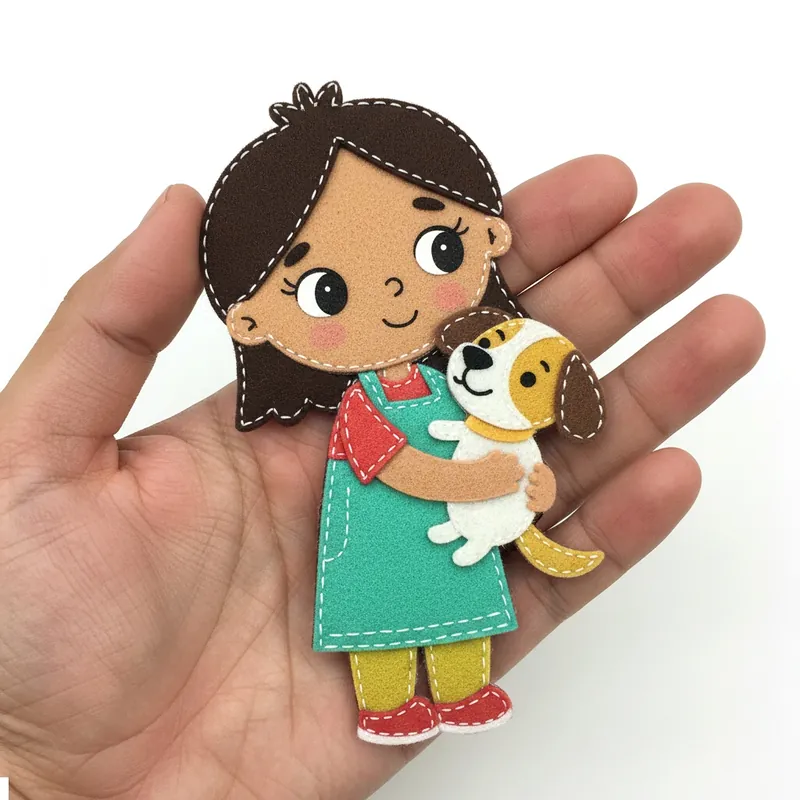 Finished felt girl in a turquoise pinafore hugging a white puppy with yellow patches
