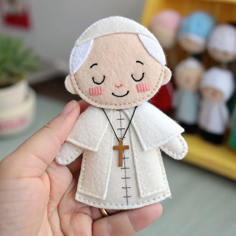 Finished felt figure of the Pope in a white cassock with a wooden cross