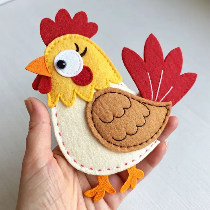 Finished felt rooster with a red comb, yellow head and brown embroidered wing