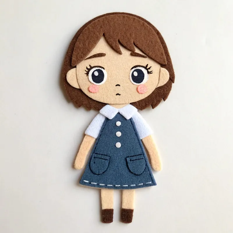 Finished kawaii felt schoolgirl doll with a brown bob in a navy dress with a white collar